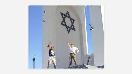 Jóvenes ucranianos hacen el saludo nazi en un monumento al Holocausto